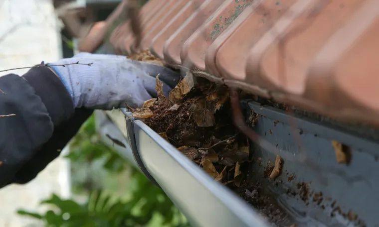 Gutter cleaning removing leaves and debris from a gutter channel