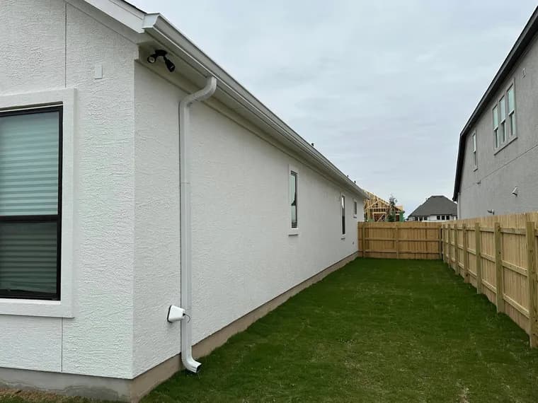 Downspout and drainage solution channeling water away from a home